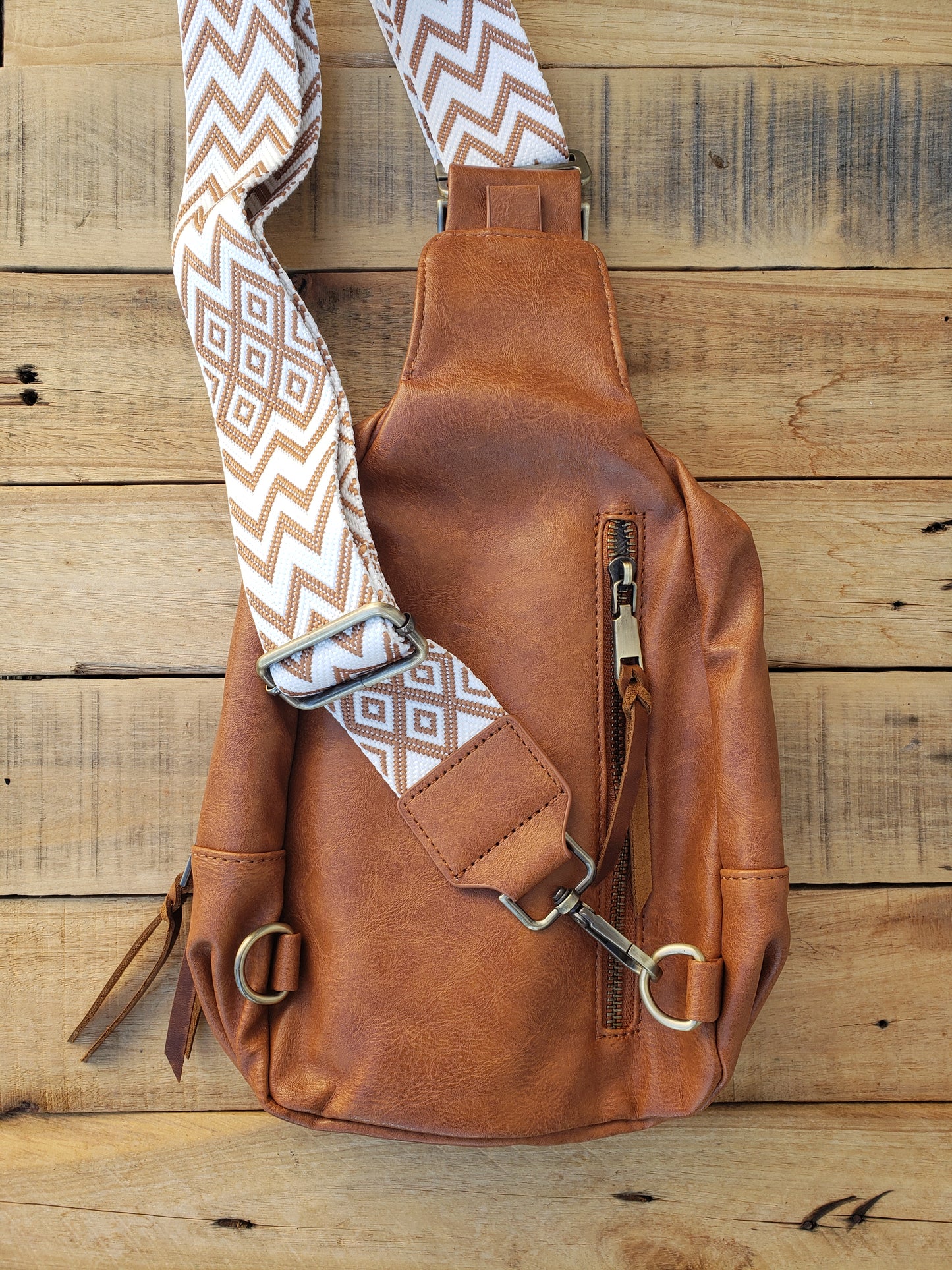 Large brown sling bag with tooled Bighorn sheep leather patch and pendleton inlay