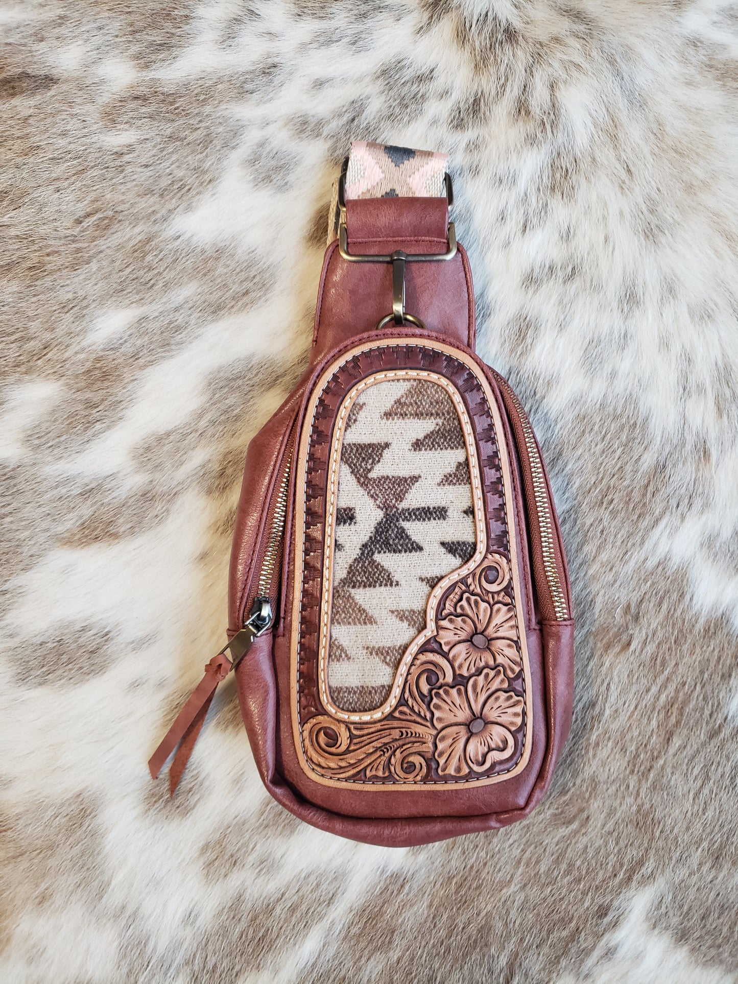 Small mahogany sling bag with tooled leather patch and fabric inlay