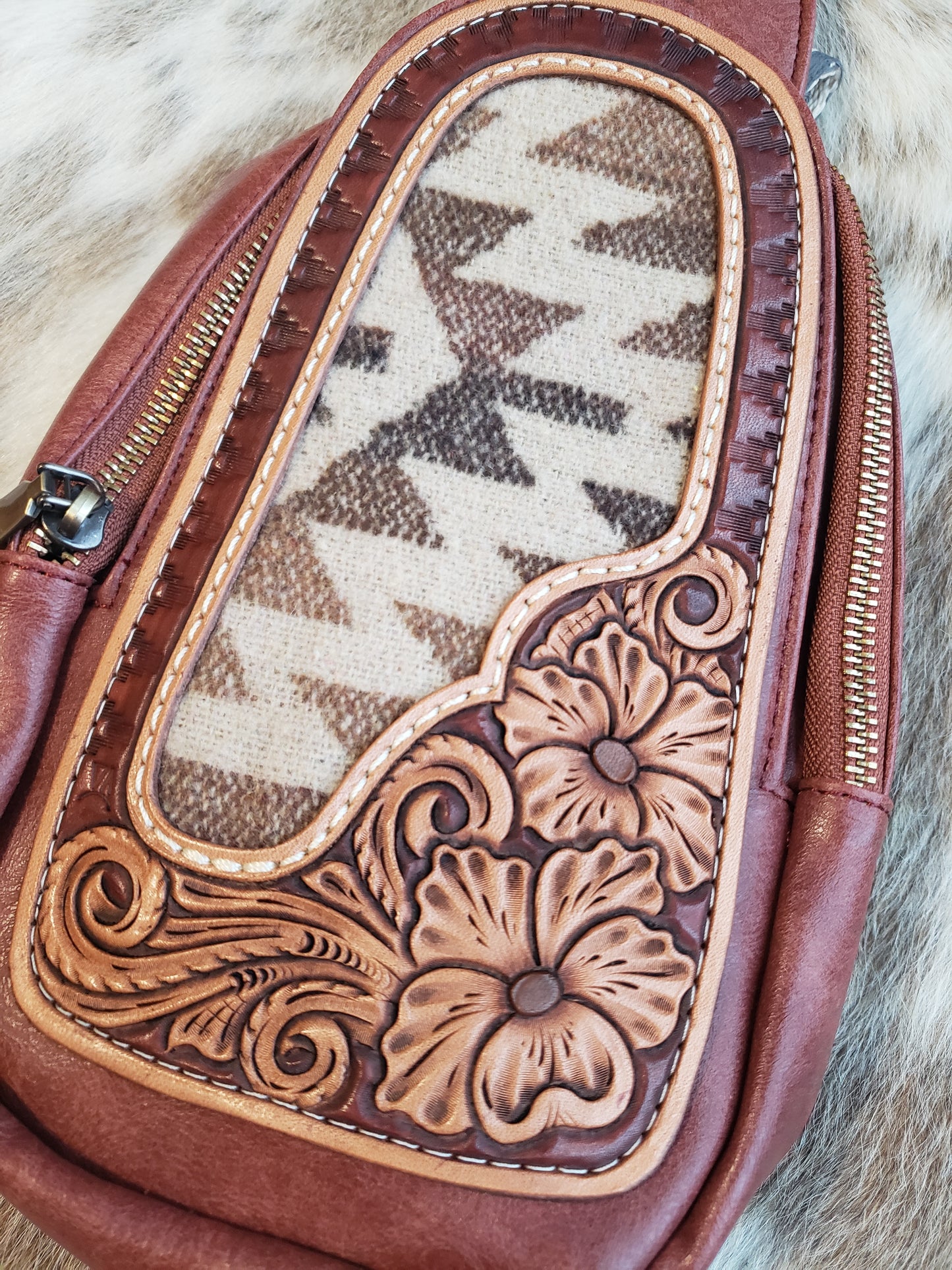 Small mahogany sling bag with tooled leather patch and fabric inlay