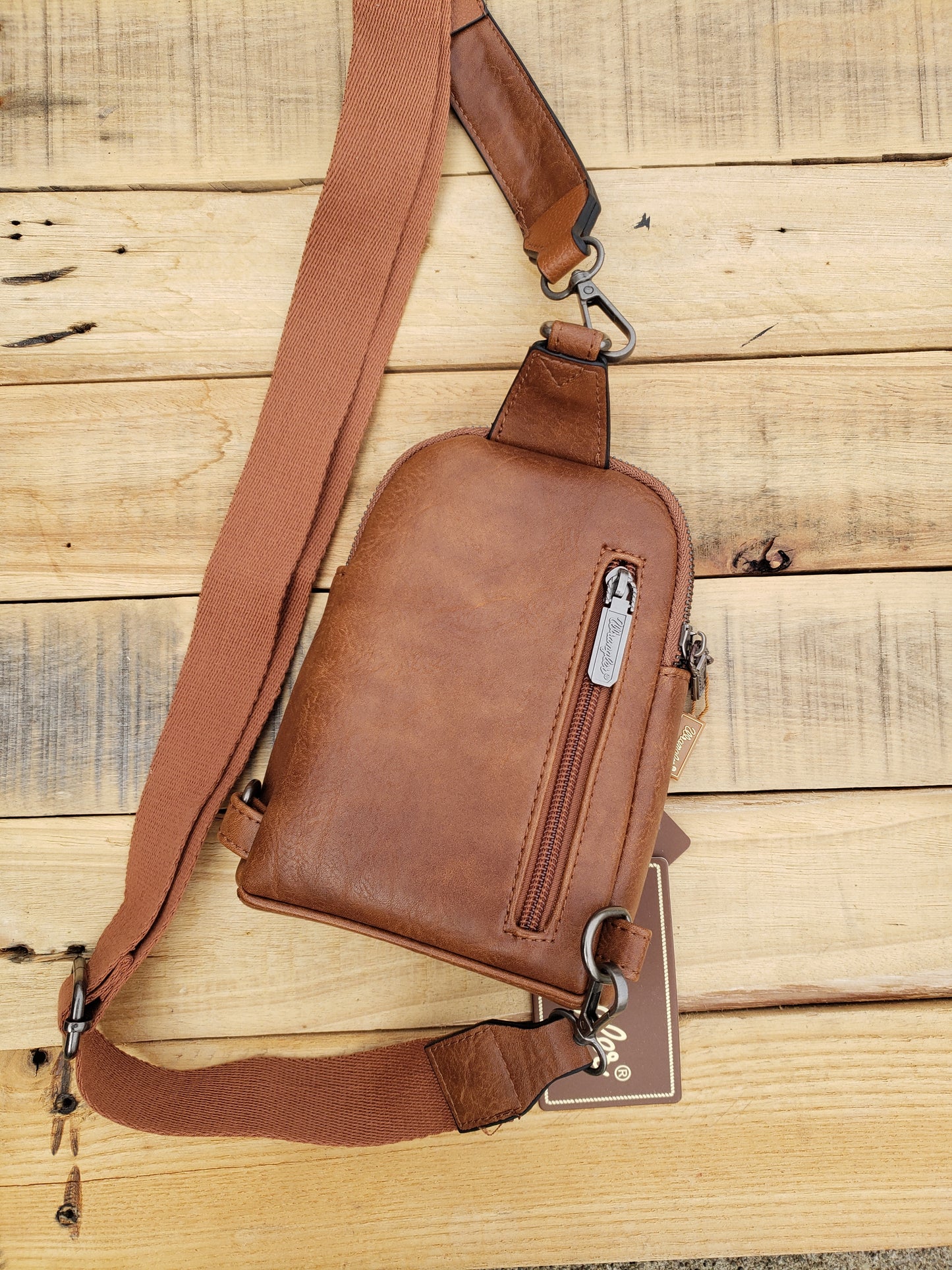 Wrangler sling bag with tooled patch with western floral and aztec