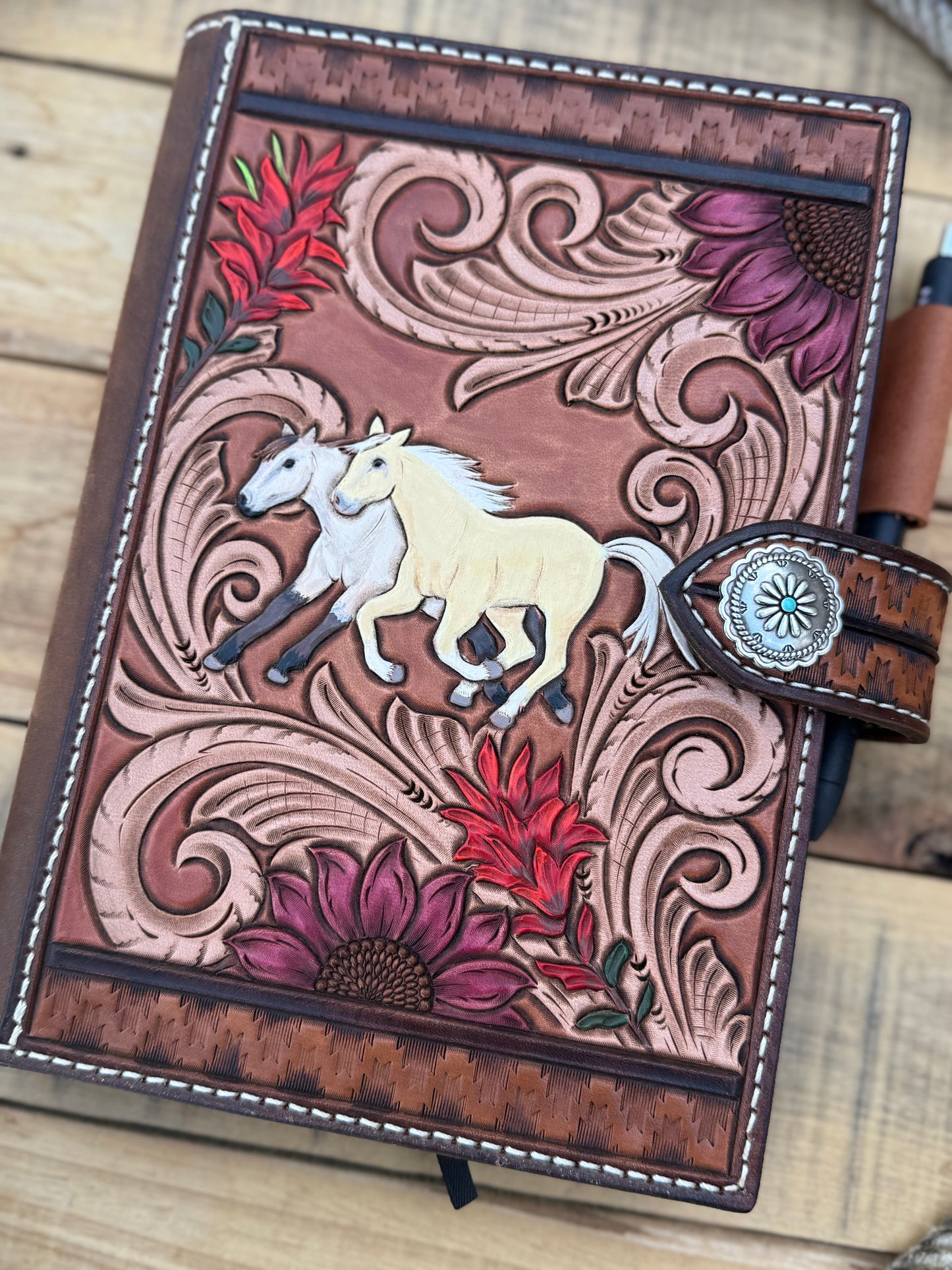Tooled leather notebook cover, horses, sunflowers, and paintbrush