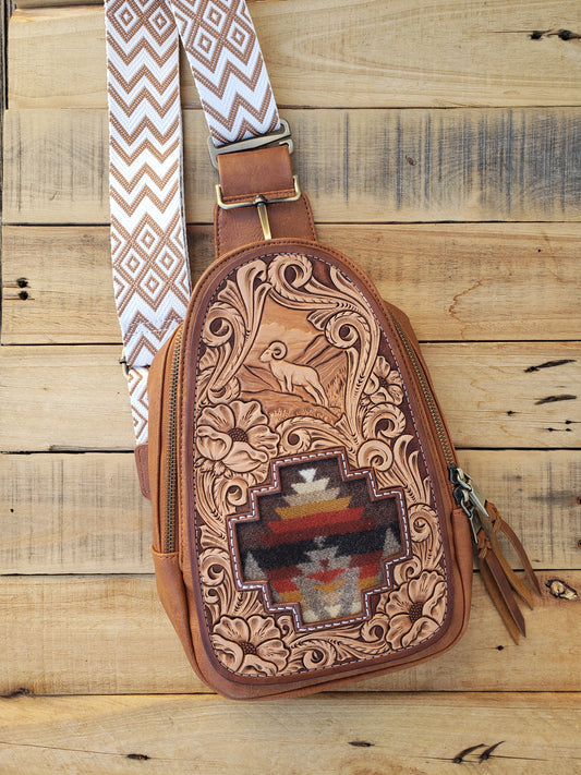 Large brown sling bag with tooled Bighorn sheep leather patch and pendleton inlay