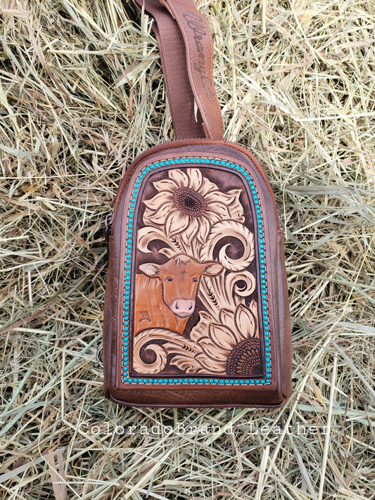 Wrangler sling bag with tooled patch with sunflowers and cow