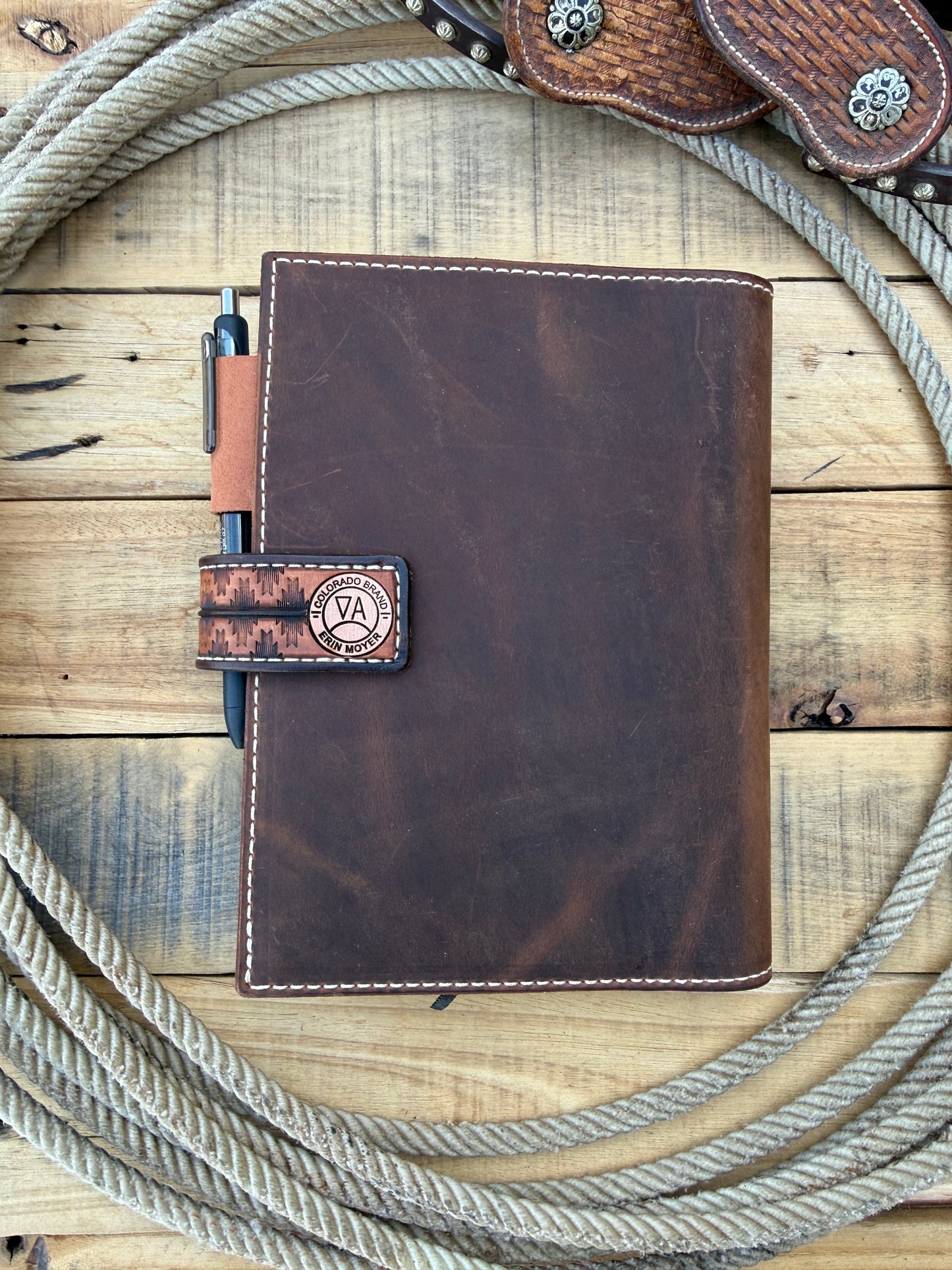 Tooled leather notebook cover, horses, sunflowers, and paintbrush